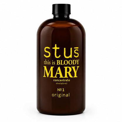 An amber brown bottle with a black cap, featuring yellow text that reads 'stus this is BLOODY MARY concentrate' on a clean white background.
