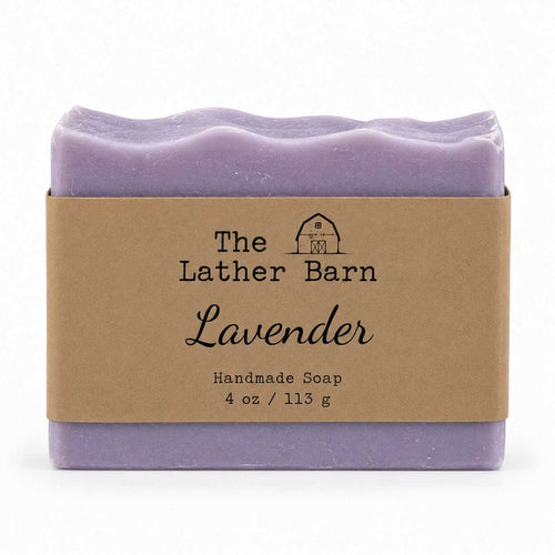 A single bar of lavender handmade soap wrapped in a kraft paper band labeled 'The Lather Barn Lavender', shown on a clean white background.