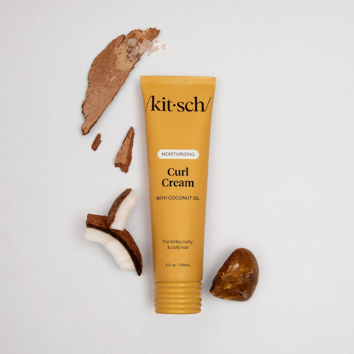 Kit-sch Curl Cream tube with coconut pieces on a light gray background