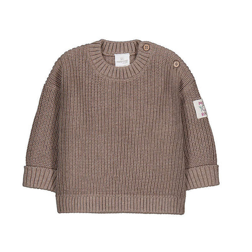 A toddler's chunky knit sweater in a warm taupe-brown color, featuring a crew neck, button closures on the shoulders, ribbed cuffs, and a small floral patch on the left sleeve.