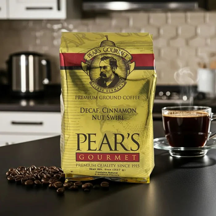 Pear's Gourmet coffee package on a kitchen counter with a cup of coffee and coffee beans.