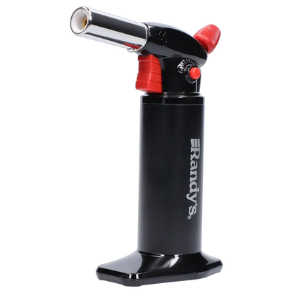 Right-side close-up of Randy's Fahrenheit Butane Torch - Black showing its black cylindrical body with white logo, angled chrome nozzle, red controls, and glossy base